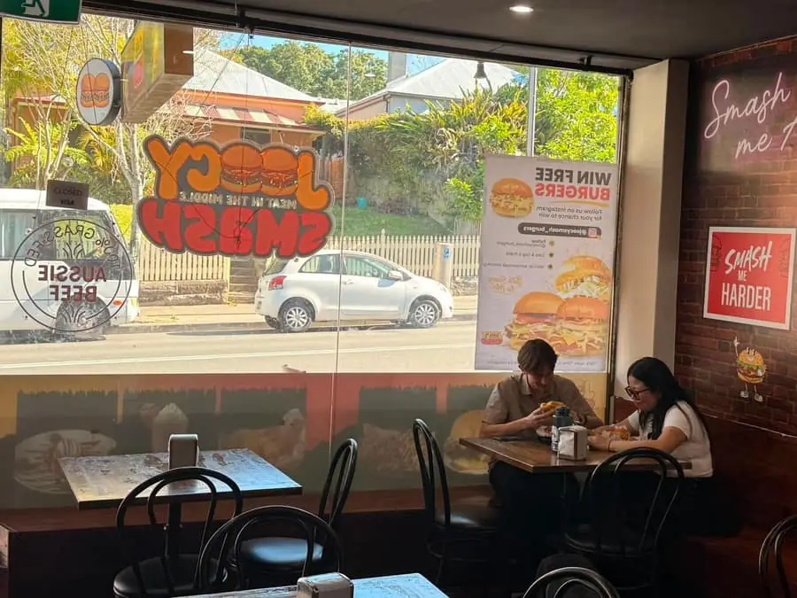 Inside Joocy Smash, customers seated at the window