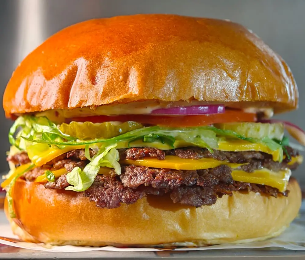 Double smash burger, cheese and toppings stacked
